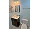 Compact powder room with a dark vanity, toilet, zebra-themed artwork, and tiled floor at 855 Hunt Club Run, Charleston, SC 29414