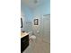Clean bathroom featuring a dark vanity, toilet, towel rack, and neutral tile floor at 855 Hunt Club Run, Charleston, SC 29414