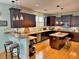 A contemporary kitchen with stainless steel appliances, dark wood cabinets, and an island with bar seating at 855 Hunt Club Run, Charleston, SC 29414