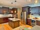 Spacious kitchen with dark wood cabinets, granite countertops, and stainless steel appliances, including a wine fridge at 855 Hunt Club Run, Charleston, SC 29414