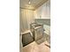 Convenient laundry room with modern washer/dryer units, cabinetry, and ample space at 855 Hunt Club Run, Charleston, SC 29414