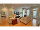 Inviting living room with light-filled windows, plush sofas, hardwood floors, and a ceiling fan at 855 Hunt Club Run, Charleston, SC 29414