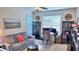Comfortable home office with gray sofa, desk, shelving, and natural light from the windows at 855 Hunt Club Run, Charleston, SC 29414