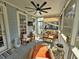 Inviting screened-in porch with cozy seating, ceiling fan, and ample light, ideal for relaxation and entertainment at 855 Hunt Club Run, Charleston, SC 29414