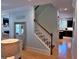 Bright stairway with wood handrail, painted risers, and views into kitchen and living areas at 855 Hunt Club Run, Charleston, SC 29414