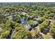 A beautiful aerial view of townhomes nestled in a lush, green, wooded area surrounding a pond with a fountain at 880 Simpkins St # 2, Charleston, SC 29412