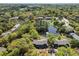 Scenic aerial view of clustered townhomes next to a pond surrounded by mature trees and green space at 880 Simpkins St # 2, Charleston, SC 29412
