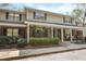 Inviting two-story townhome with a brick facade, covered porch, and colorful flower beds at 880 Simpkins St # 2, Charleston, SC 29412