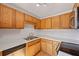 Functional kitchen equipped with wooden cabinets, sleek countertops, and stainless steel appliances at 880 Simpkins St # 2, Charleston, SC 29412