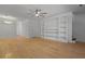 Open-concept living area with built-in shelves, hardwood floors, and modern ceiling fan at 880 Simpkins St # 2, Charleston, SC 29412