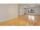 Bright living area with hardwood floors, built-in shelving, and a ceiling fan near a window at 880 Simpkins St # 2, Charleston, SC 29412