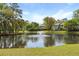 Scenic pond with a fountain surrounded by trees and residential homes at 880 Simpkins St # 2, Charleston, SC 29412