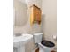 Cozy half bathroom with a pedestal sink, storage cabinet, and updated fixtures at 9226 Southern Oak Ln, Ladson, SC 29456