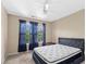 Bedroom featuring a ceiling fan, large window, and plush mattress on a modern platform bed at 9226 Southern Oak Ln, Ladson, SC 29456