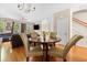 Cozy dining area with hardwood floors, a round table, and adjacent living space at 9226 Southern Oak Ln, Ladson, SC 29456