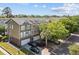 Charming townhomes boast colorful exteriors, garages, and landscaped yards under a sunny sky at 9226 Southern Oak Ln, Ladson, SC 29456