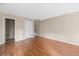 Spacious living room with wood floors, a white door, and neutral paint at 9226 Southern Oak Ln, Ladson, SC 29456