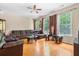 Bright living room featuring large windows, neutral walls, and comfortable seating arrangements at 9226 Southern Oak Ln, Ladson, SC 29456