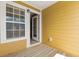 Exterior view of a covered porch, featuring wood floors and yellow siding at 9226 Southern Oak Ln, Ladson, SC 29456