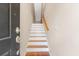 View of an entry staircase featuring hardwood treads, white risers, and a wooden handrail at 9226 Southern Oak Ln, Ladson, SC 29456