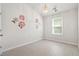 Bright bedroom featuring floral wall decor, a ceiling fan, and plank flooring at 9428 Sweep Dr, Summerville, SC 29485
