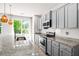 Modern kitchen with granite countertops, stainless steel appliances, and tile backsplash at 9428 Sweep Dr, Summerville, SC 29485