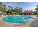 Resort-style pool with a vibrant red barn-style pavilion, inviting relaxation and recreation at 9428 Sweep Dr, Summerville, SC 29485