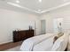 Spacious bedroom featuring modern décor, a beautiful wood dresser, and ensuite bathroom at 1016 Sagegrass St, Summerville, SC 29485