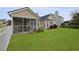The spacious backyard features a screened lanai and lush lawn, perfect for outdoor living at 1047 Tyron Cir, Charleston, SC 29414