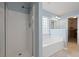 Bright bathroom with white shower, tub, tile, and glass block window at 1047 Tyron Cir, Charleston, SC 29414