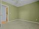 Bedroom with green walls, carpeted floor, and doorway to a laundry room at 1047 Tyron Cir, Charleston, SC 29414