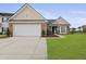 Charming brick and siding home featuring a two-car garage and manicured front lawn at 1047 Tyron Cir, Charleston, SC 29414