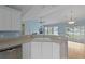 Kitchen features white cabinets, stainless appliances, and views to the water at 1047 Tyron Cir, Charleston, SC 29414