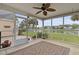 Relaxing screened-in porch with a decorative rug and outdoor view of palm trees and a lake at 1047 Tyron Cir, Charleston, SC 29414