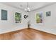 Bright dining room features hardwood floors, neutral walls, chandelier and two large windows at 105 Dalton Ave, North Charleston, SC 29420