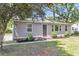 Well-kept home with gray siding, updated landscaping, and a charming wreath adorning the front door at 105 Dalton Ave, North Charleston, SC 29420