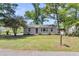 Charming single-story home with gray siding, a lush lawn, mature trees, and a welcoming mailbox at 105 Dalton Ave, North Charleston, SC 29420
