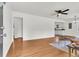 Spacious living room with hardwood floors, a ceiling fan, and an open view to the kitchen area at 105 Dalton Ave, North Charleston, SC 29420