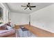 Comfortable living room featuring hardwood floors, natural lighting, and a cozy seating arrangement with a modern ceiling fan at 105 Dalton Ave, North Charleston, SC 29420