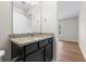 Bathroom with granite countertops, dark cabinets, and a large mirror at 1086 Lexi Ct, Ladson, SC 29456