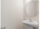 Half bathroom features a pedestal sink and oval mirror at 1086 Lexi Ct, Ladson, SC 29456