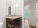 Bright bathroom with granite vanity, mirror, and access to other rooms at 1086 Lexi Ct, Ladson, SC 29456