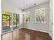 Bright dining room with wood floors and a sliding glass door leading to an outdoor patio at 1086 Lexi Ct, Ladson, SC 29456