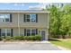 A charming townhouse with olive green siding, black shutters, and a well-maintained front lawn at 1086 Lexi Ct, Ladson, SC 29456