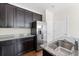 Well-equipped kitchen boasts dark wood cabinets, granite countertops, and stainless steel appliances at 1086 Lexi Ct, Ladson, SC 29456