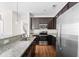 Modern kitchen with granite countertops, stainless steel appliances and dark wood cabinetry at 1086 Lexi Ct, Ladson, SC 29456