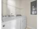 Functional laundry room with a washer, dryer, and wire shelving for ample storage at 1086 Lexi Ct, Ladson, SC 29456