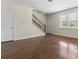 Welcoming living room featuring wood floors, staircase, and ample natural light from the windows at 1086 Lexi Ct, Ladson, SC 29456