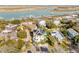 Stunning aerial view of the home with solar panels, lush landscaping, and picturesque waterway at 109 Carolina Blvd, Isle of Palms, SC 29451
