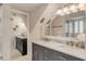 Bathroom showcasing a marble countertop with double sinks and mirrors and adjacent walk-in shower at 109 Carolina Blvd, Isle of Palms, SC 29451